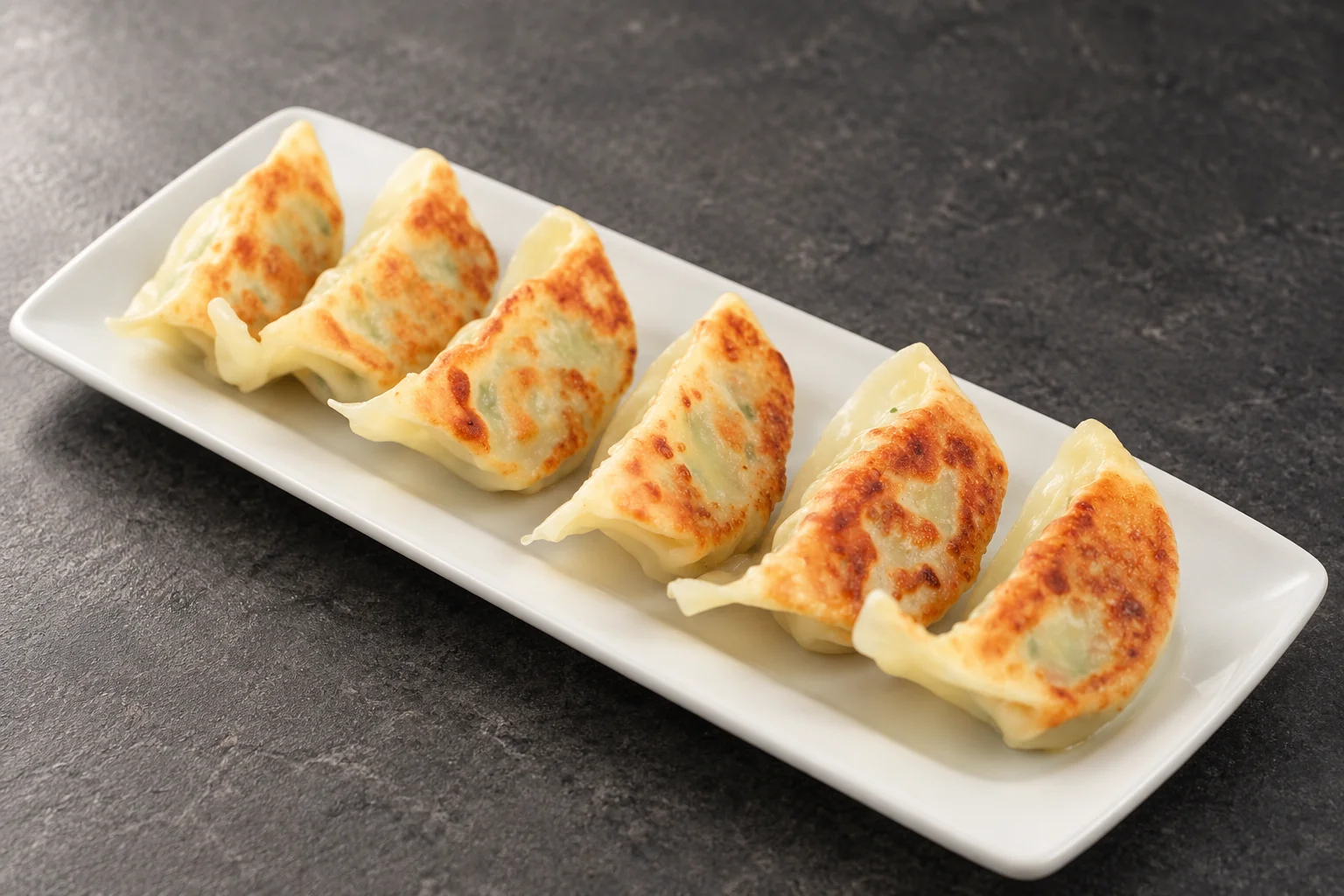 Dumplings on a white plate.